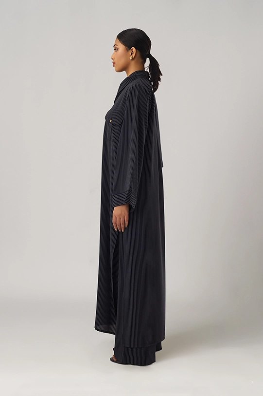 Black oversized shirt paired with wide-leg pants.