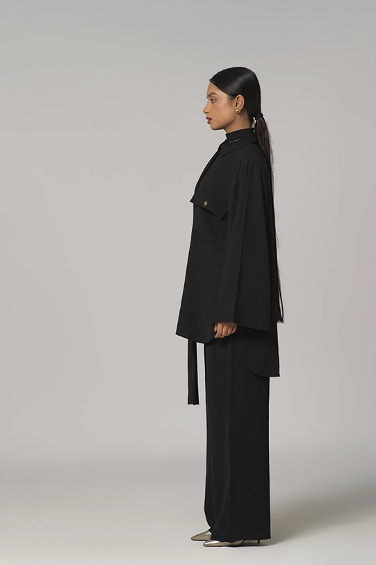 Black oversized shirt paired with wide-leg pants.