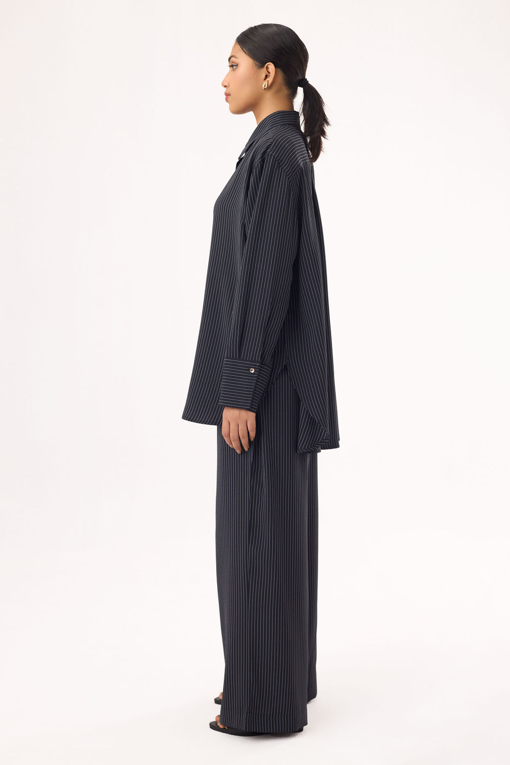 Black oversized shirt paired with wide-leg pants